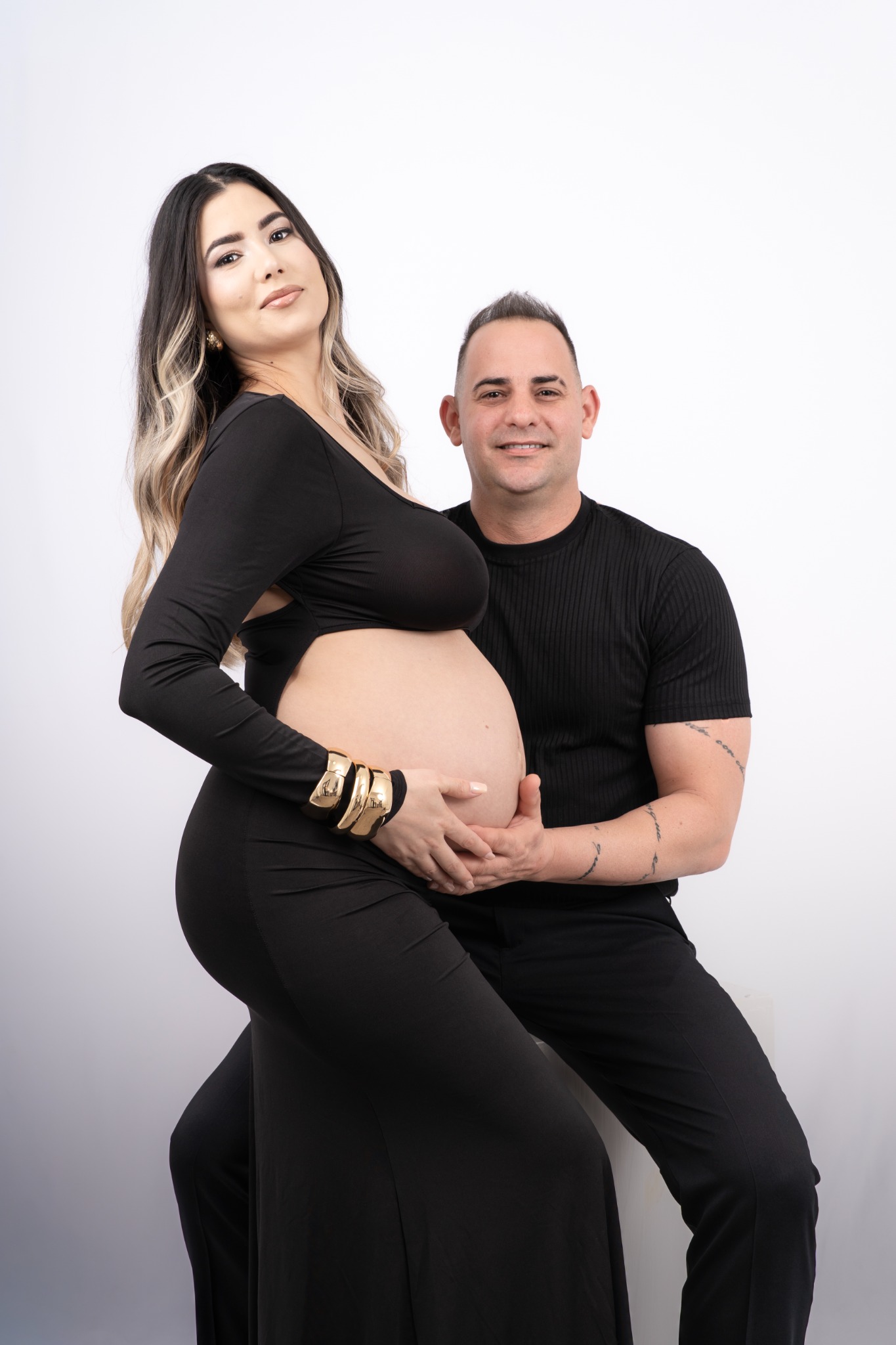 Retrato de maternidad en estudio junto a la pareja